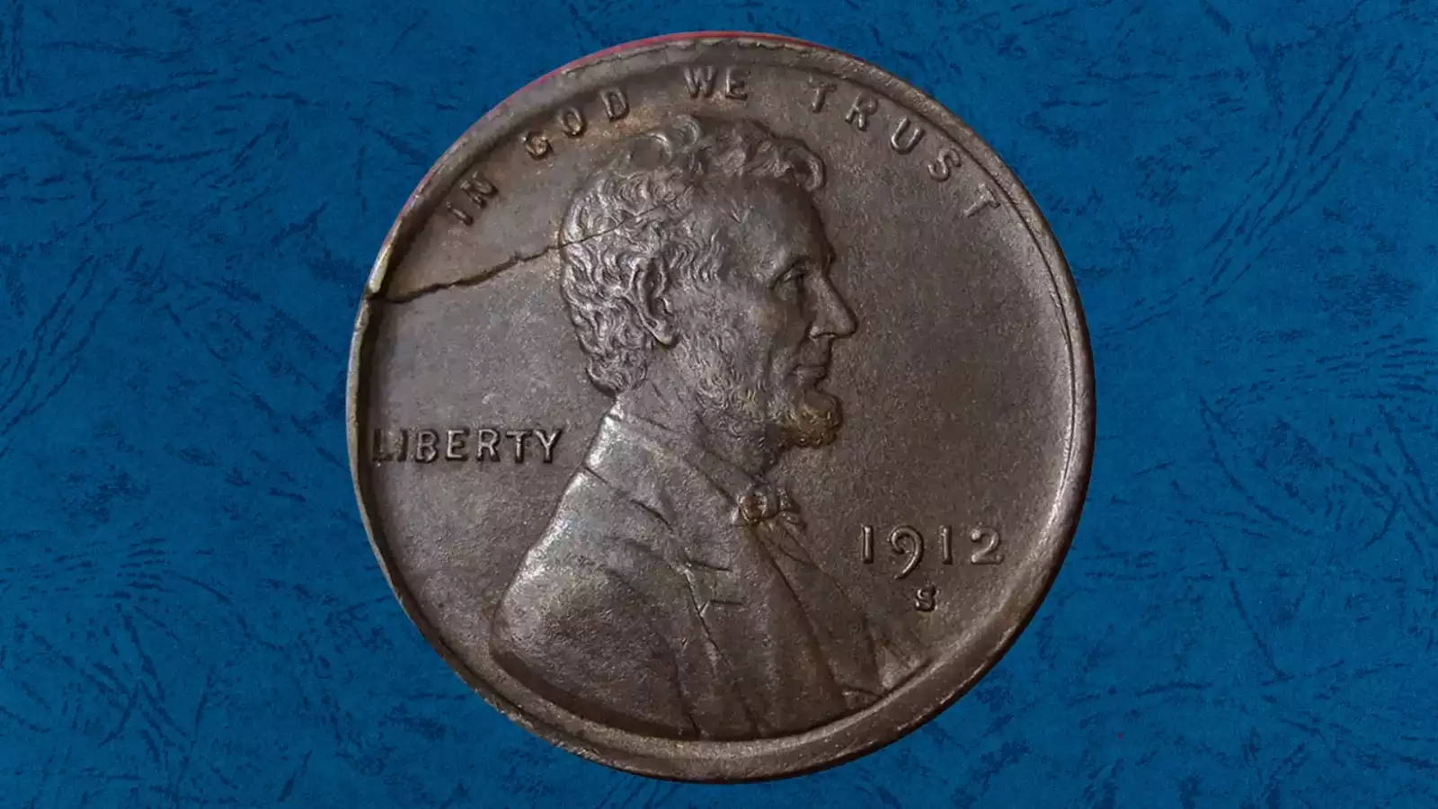 1912 Lincoln wheat penny die cud break error showing raised blob of copper at the rim